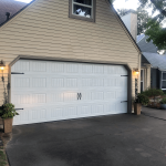 white garage door with decorative hardware on residential home