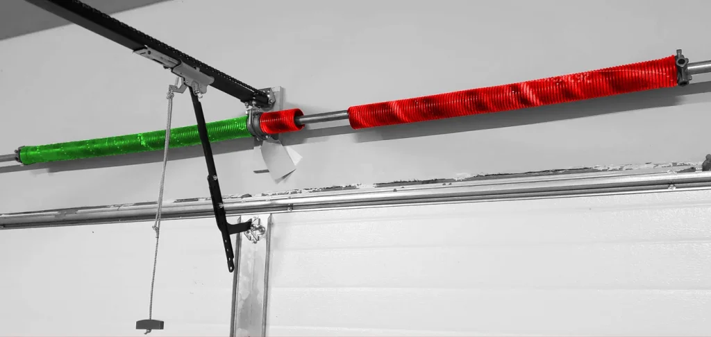 Broken garage door torsion spring (red) replaced with new spring (green) by Discount Garage Door in Oklahoma